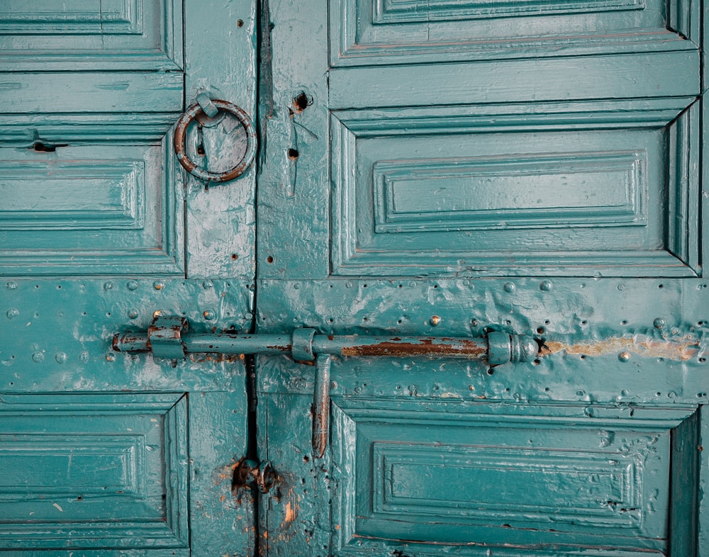 close-up photography of teal door