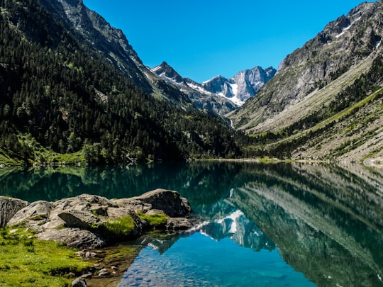 body of water beside mountain in Lac de Gaube France