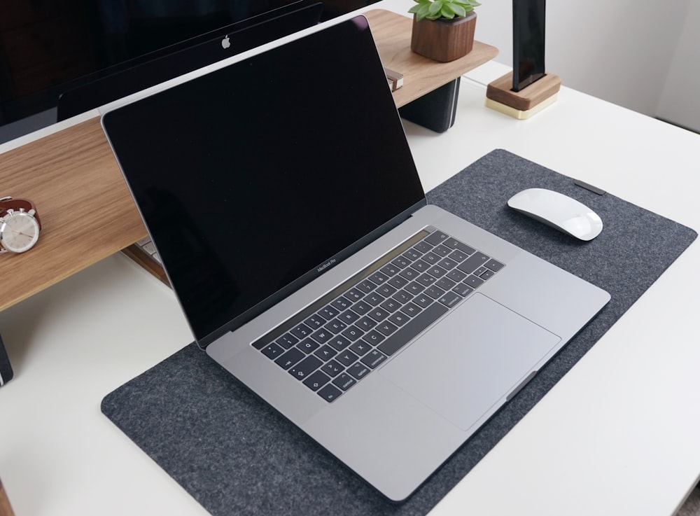 a laptop computer sitting on top of a mouse pad