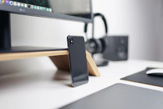 A sleek modern workspace featuring a laptop, smartphone, and headphones, showcasing the latest electronics available at impexa.