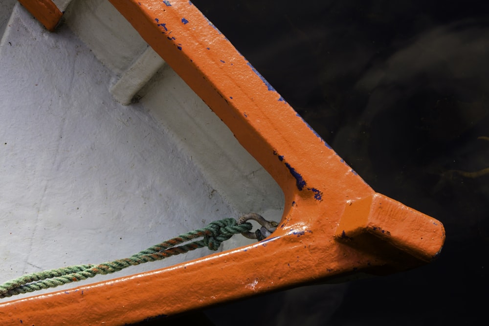 a close up of an orange and white boat in the water