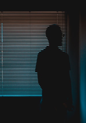 silhouette of man near window