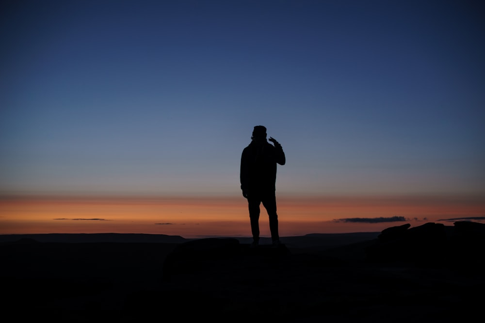 man standing on ground photo