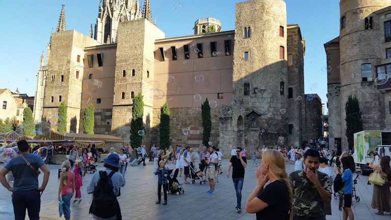 A lively public square event with performers and an enthusiastic audience