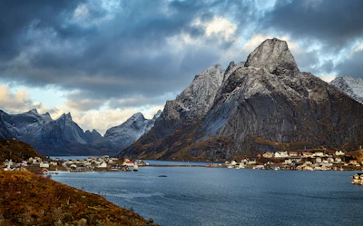 The red fishing houses of Reine below the snow-topped peaks of Lofoten, Norway