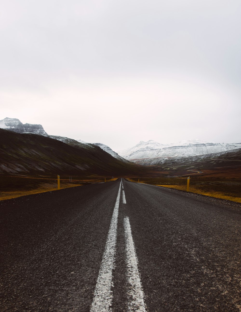 gray asphalt road under cloudy sky