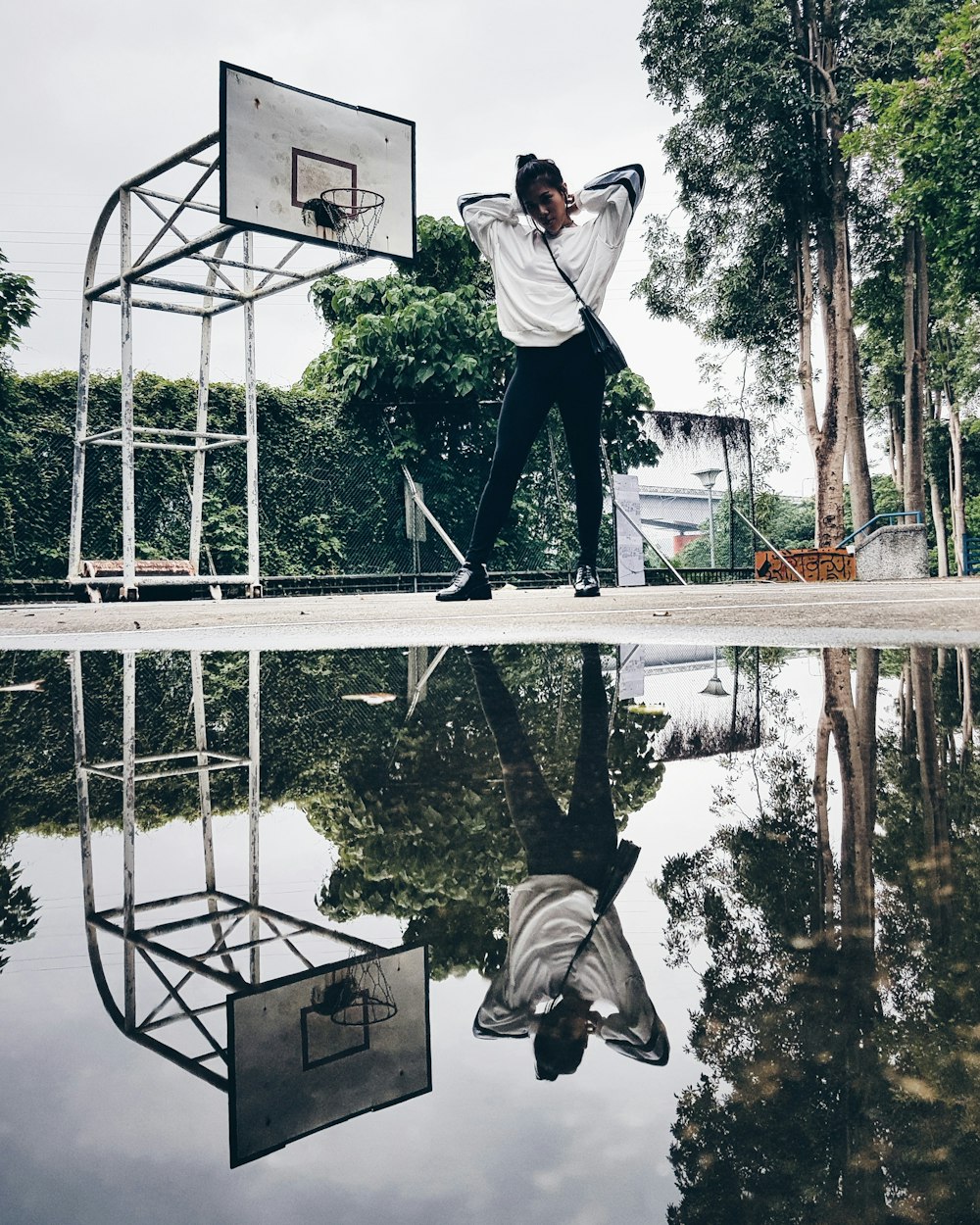 woman standing on basketball court with water reflection