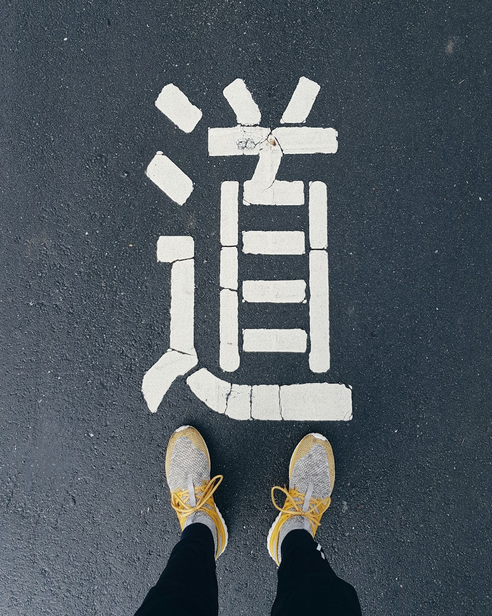 man standing on gray concrete road