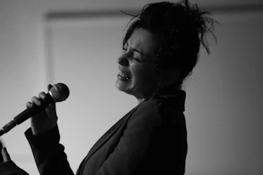 Close-up of the lead singer passionately singing into the microphone