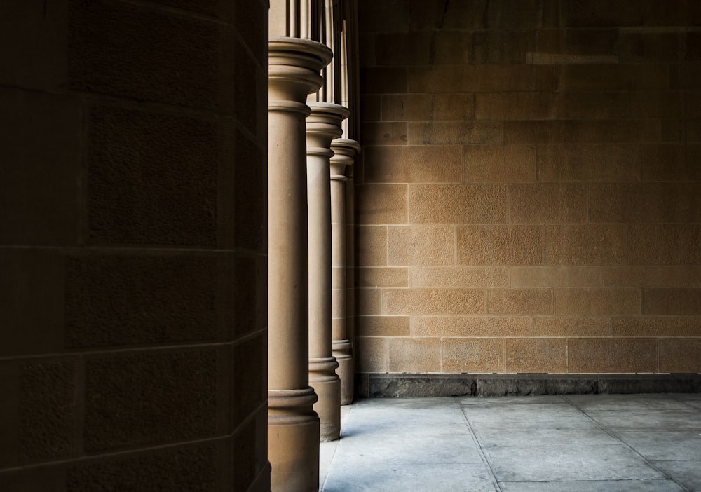 three brown concrete post during daytime