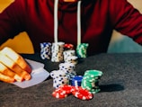 person sitting near poker chips
