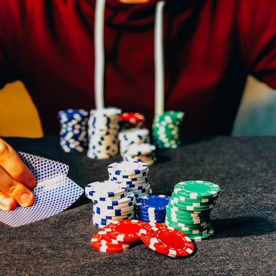 person sitting near poker chips