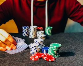 person sitting near poker chips