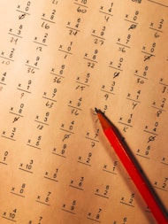 A cheerful tutor helping a student with math homework.