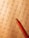A math worksheet filled with various multiplication and division problems is accompanied by a red pencil resting on the paper. The writing appears to be handwritten, with some numbers scribbled or crossed out as part of corrections or workings.