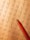 A math worksheet filled with various multiplication and division problems is accompanied by a red pencil resting on the paper. The writing appears to be handwritten, with some numbers scribbled or crossed out as part of corrections or workings.