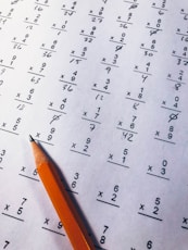 brown pencil on equation paper