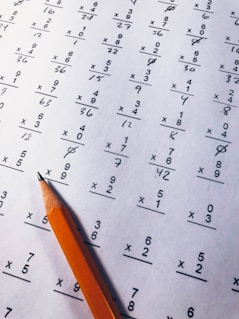 brown pencil on equation paper