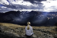 woman sitting on gray stone