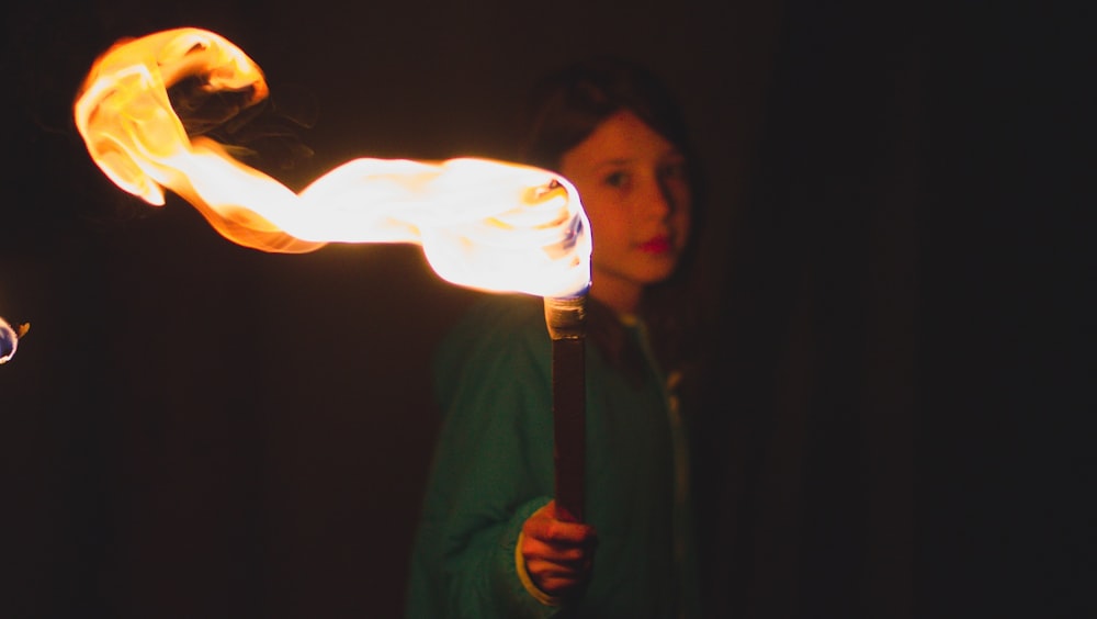 person holding torch during night time