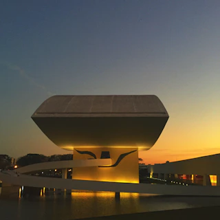 Evening view of a tensile shed softly illuminated, highlighting its elegant curves and craftsmanship.