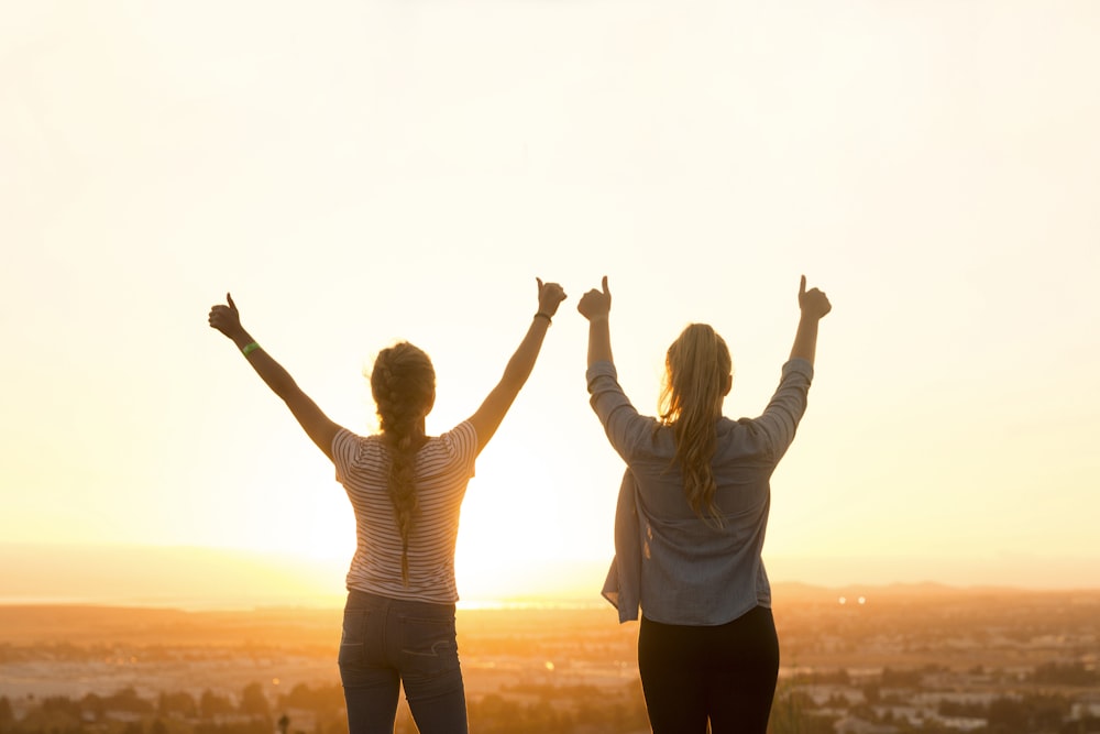 two woman standing near field