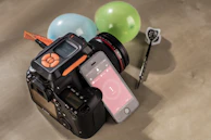 Close-up of a DSLR camera capturing candid smiles at a birthday party.