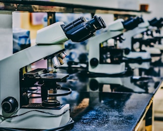 white microscope on top of black table