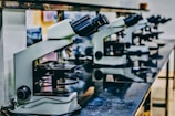 white microscope on top of black table