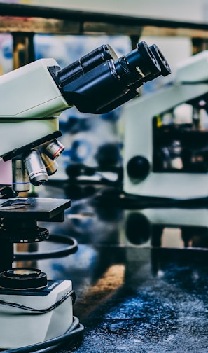 white microscope on top of black table