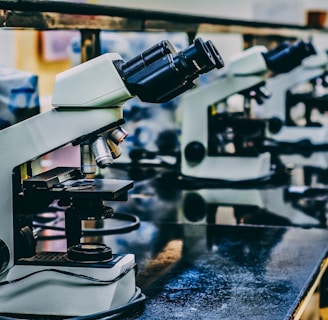 white microscope on top of black table