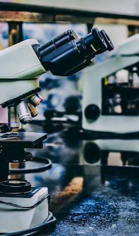 white microscope on top of black table