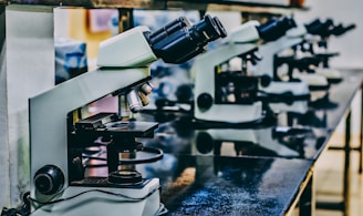 white microscope on top of black table