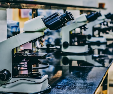 white microscope on top of black table