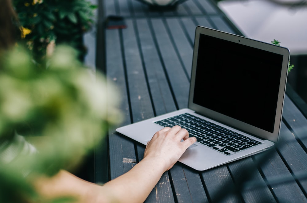 person holding turned off laptop