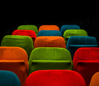 Close-up of colorful theater tickets arranged neatly on a vibrant background.