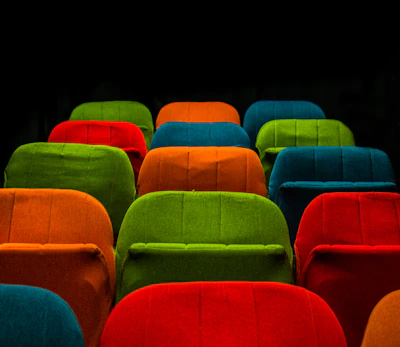 Close-up of colorful theater tickets arranged neatly on a vibrant background.