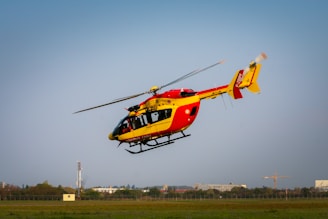 yellow and red helicopter on the sky