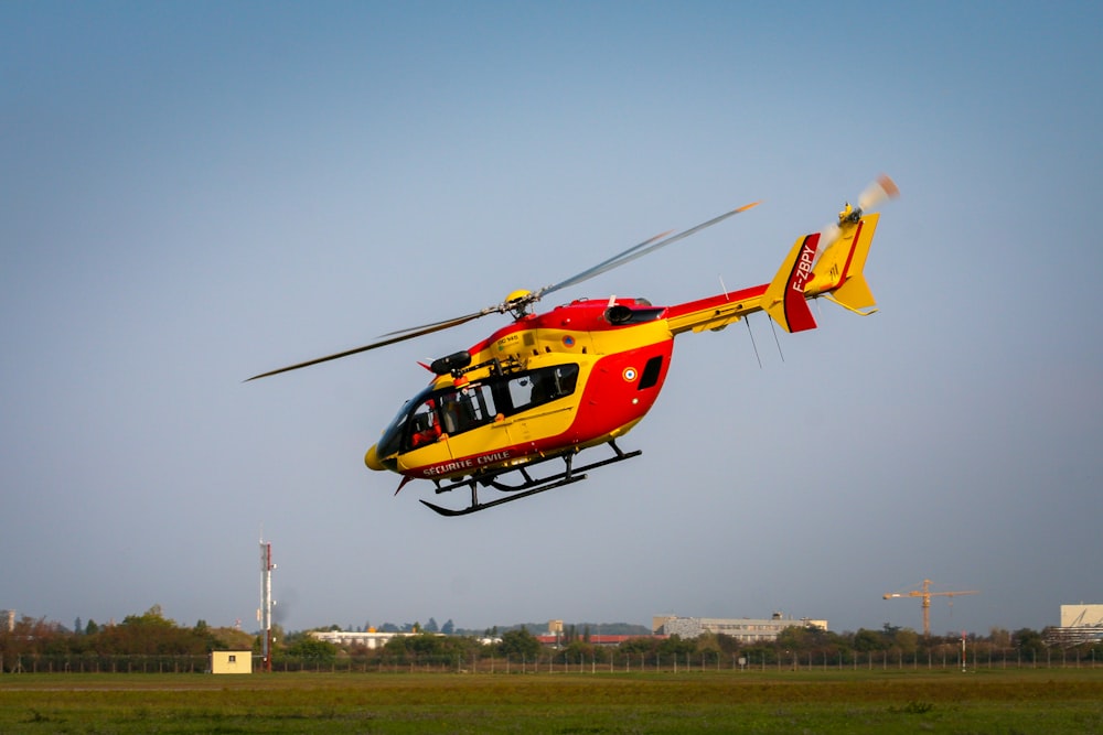 yellow and red helicopter on the sky