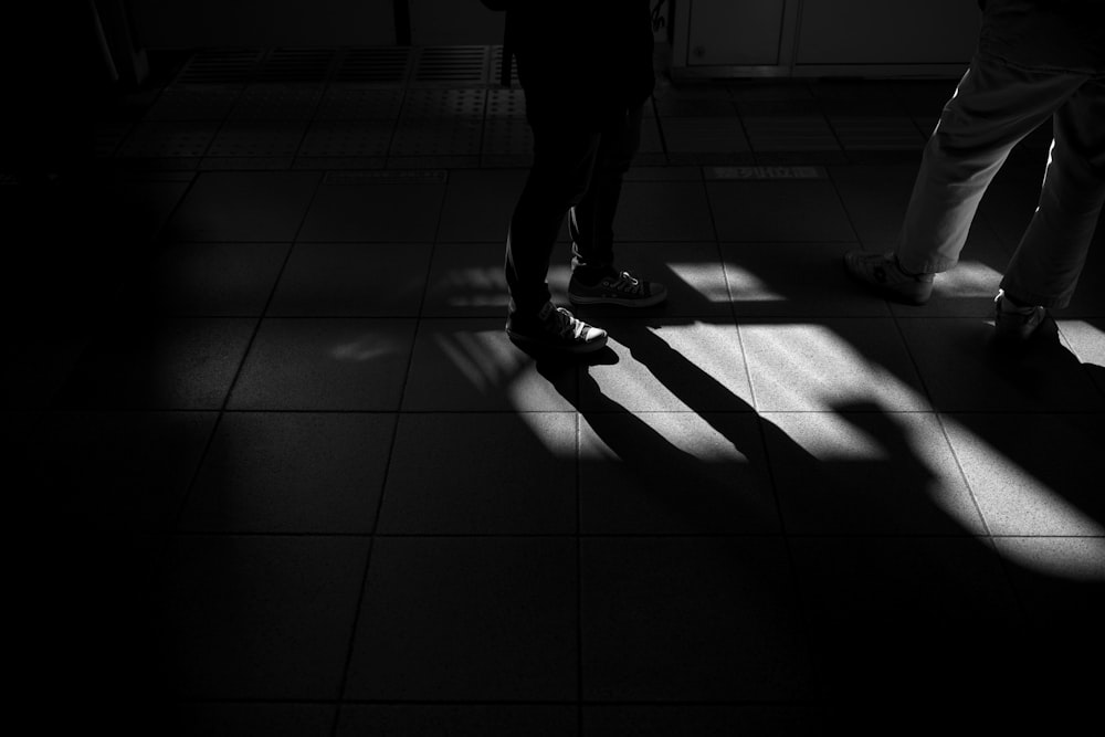 two person standing on white tile