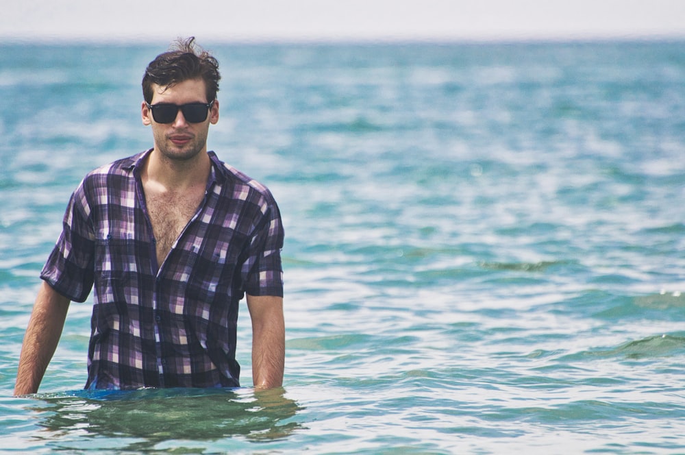 man standing on body of water during daytime