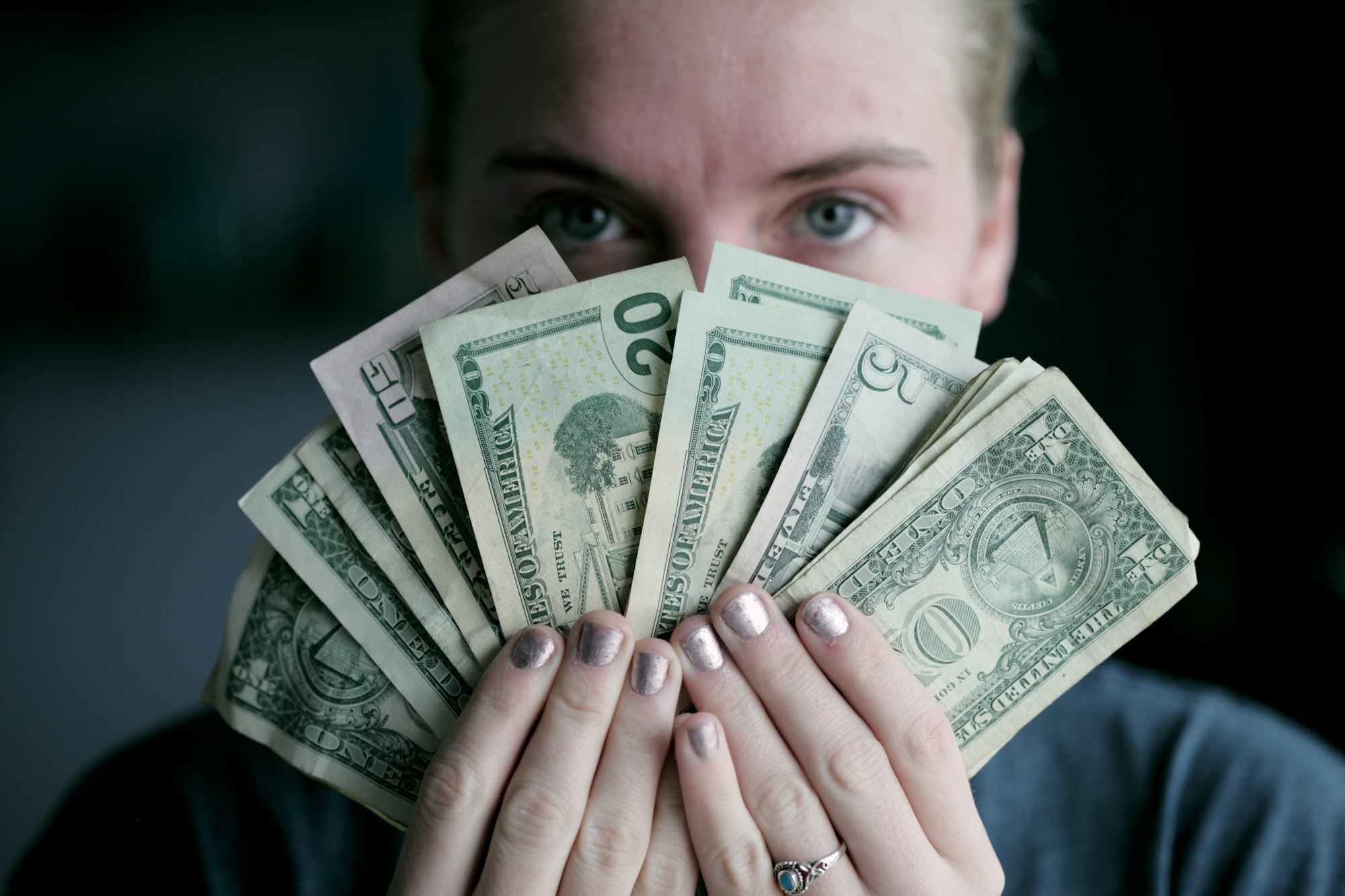 Young woman holding money.