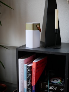 A minimalist shelf showcasing a variety of cumulus radio speakers in different shapes and colors.