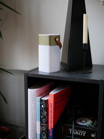 A minimalist shelf showcasing a variety of cumulus radio speakers in different shapes and colors.