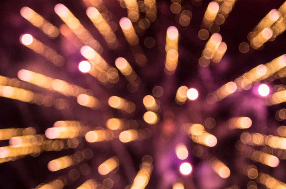 a close up of a fireworks display with blurry lights