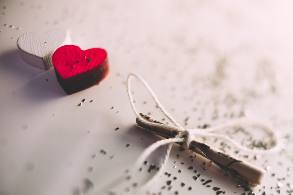 macro shot photography of red and white heart ornament