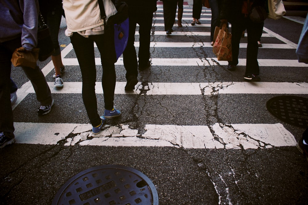 group of person walking on pedestrian lane