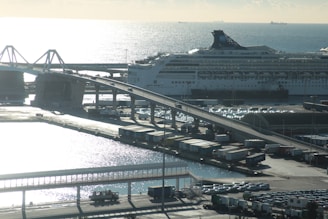 A cruise ship docked at the port with a Mercedes van waiting to transfer passengers.