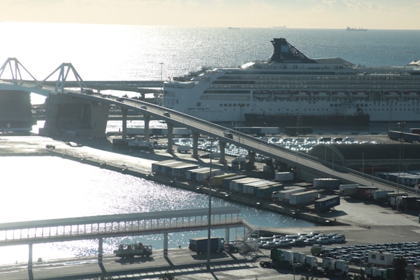 A cruise ship docked at the port with a Mercedes van waiting to transfer passengers.