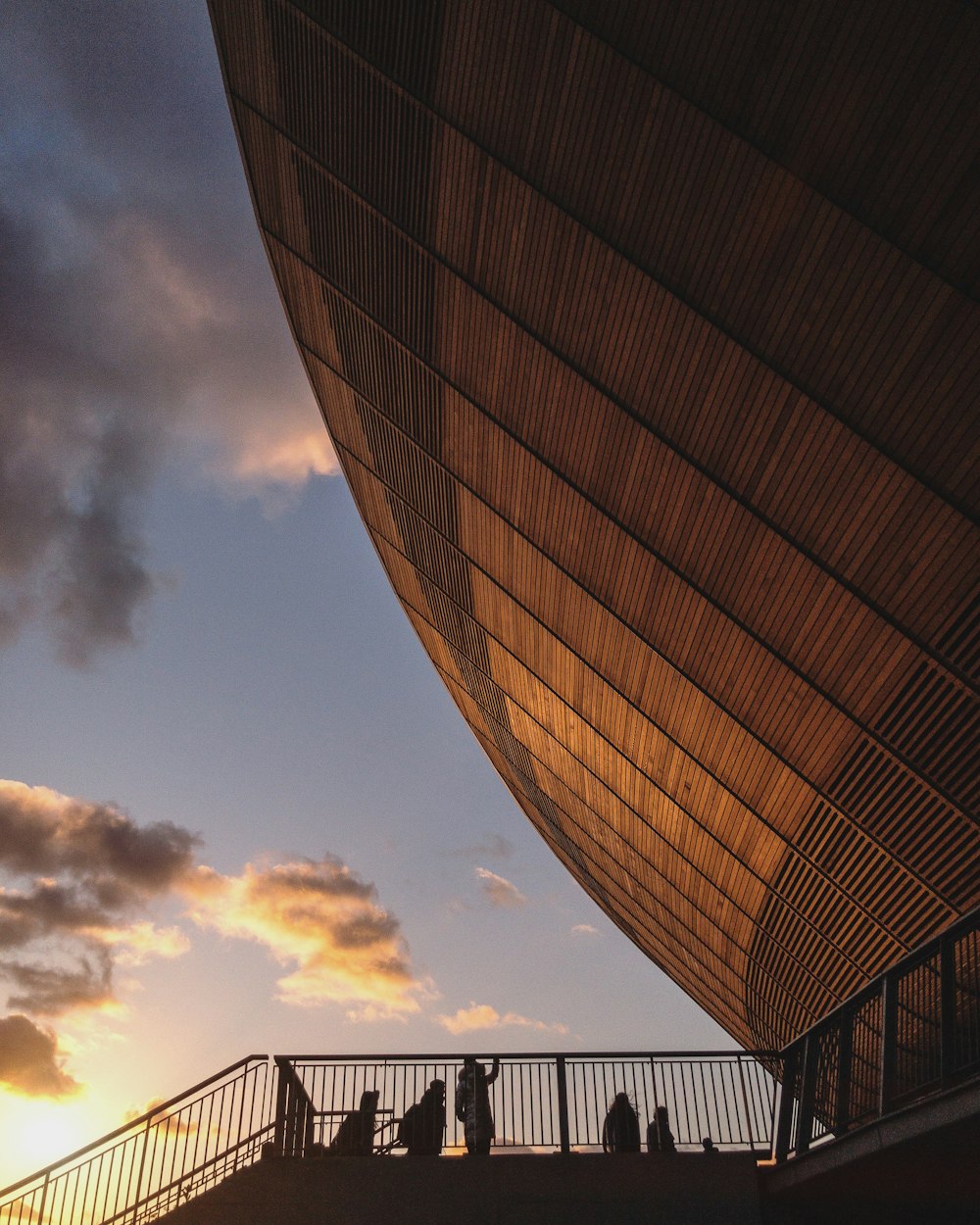 silhouette of people on stair near brown building